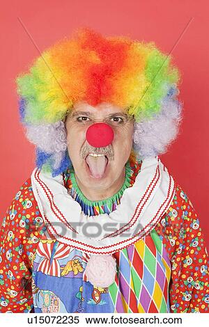 Portrait of senior male clown sticking out tongue over red background View Large Photo Image Stock Photography - Portrait of senior male clown sticking out tongue over red background. Fotosearch