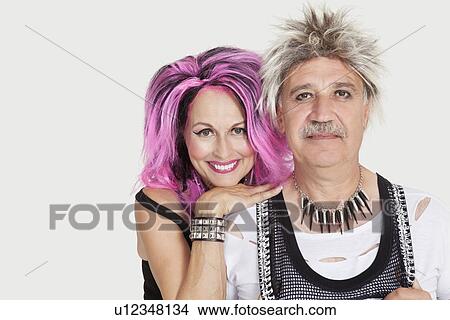 Picture - Portrait of senior punk couple over gray background. Fotosearch