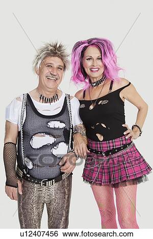 Portrait of senior punk couple standing with arm in arm over gray background View Large Photo Image Stock Photograph - Portrait of senior punk couple standing with arm in arm over gray background. Fotosearch