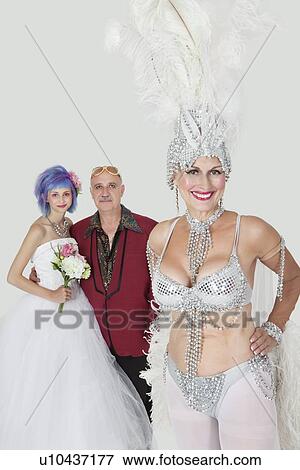 Portrait of senior showgirl with father and daughter in wedding dress against gray background View Large Photo Image Stock Photo - Portrait of senior showgirl with father and daughter in wedding dress against gray background. Fotosearch