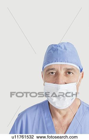 Portrait of senior surgeon with surgical cap and mask over gray background View Large Photo Image Stock Image - Portrait of senior surgeon with surgical cap and mask over gray background. Fotosearch