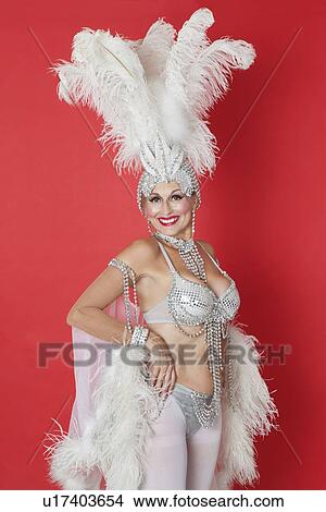 Portrait of senior woman in showgirl's outfit and feather headpiece over red background View Large Photo Image Picture - Portrait of senior woman in showgirl's outfit and feather headpiece over red background. Fotosearch