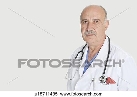 Portrait of serious senior medical practitioner with stethoscope over gray background View Large Photo Image Stock Photography - Portrait of serious senior medical practitioner with stethoscope over gray background. Fotosearch