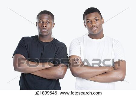 Portrait of two African American male friends with arms crossed over gray background View Large Photo Image Stock Photography - Portrait of two African American male friends with arms crossed over gray background. Fotosearch