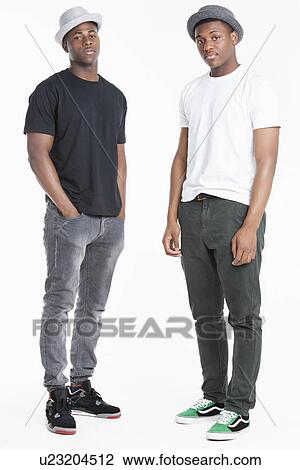 Stock Image - Portrait of two young African American men in casuals over gray background. Fotosearch