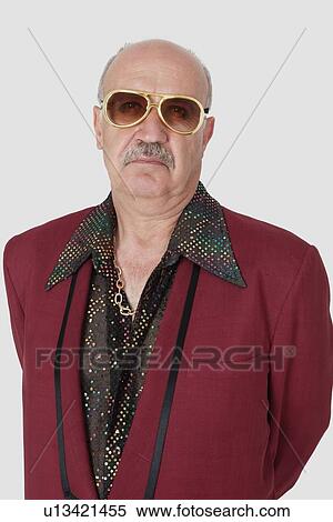 Portrait of unhappy senior man wearing sunglasses against gray background View Large Photo Image Stock Photography - Portrait of unhappy senior man wearing sunglasses against gray background. Fotosearch