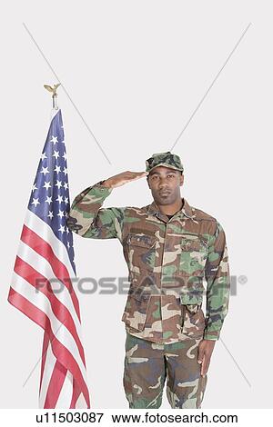 Portrait of US Marine Corps soldier saluting American flag over gray background View Large Photo Image Stock Photo - Portrait of US Marine Corps soldier saluting American flag over gray background. Fotosearch