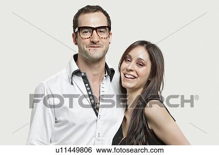 Portrait of young couple smiling together against gray background View Large Photo Image Stock Photograph - Portrait of young couple smiling together against gray background. Fotosearch