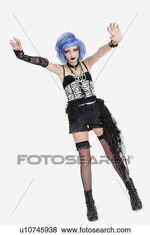 Portrait of young female punk hand gesturing over gray background View Large Photo Image Stock Photo - Portrait of young female punk hand gesturing over gray background. Fotosearch