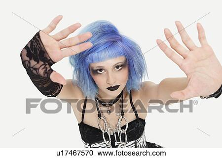 Portrait of young female punk making a stop gesture over gray background View Large Photo Image Stock Image - Portrait of young female punk making a stop gesture over gray background. Fotosearch