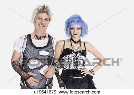 Portrait of young female punk standing arm in arm with senior man wearing ripped clothes over gray background View Large Photo Image Stock Photo - Portrait of young female punk standing arm in arm with senior man wearing ripped clothes over gray background. Fotosearch