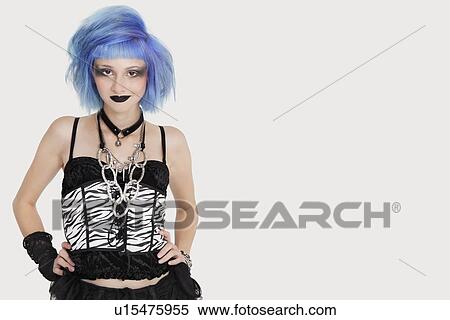 Stock Photography - Portrait of young female punk with dyed hair over gray background. Fotosearch