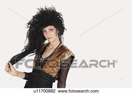 Portrait of young Goth woman with teased hair over gray background View Large Photo Image Stock Image - Portrait of young Goth woman with teased hair over gray background. Fotosearch