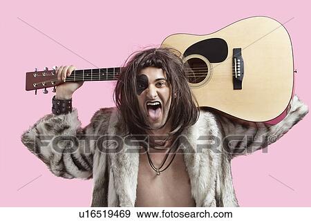 Portrait of young male musician with mouth open and holding guitar against pink background View Large Photo Image Stock Photo - Portrait of young male musician with mouth open and holding guitar against pink background. Fotosearch