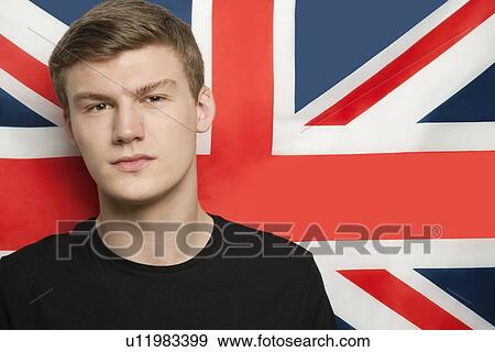 Stock Photo - Portrait of young man against British flag. Fotosearch