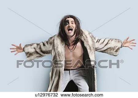 Portrait of young man in fur coat screaming against light blue background View Large Photo Image Stock Image - Portrait of young man in fur coat screaming against light blue background. Fotosearch