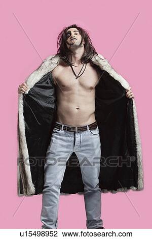 Portrait of young man wearing fur coat over pink background View Large Photo Image Stock Image - Portrait of young man wearing fur coat over pink background. Fotosearch
