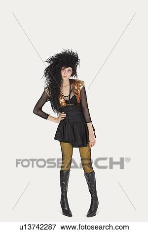 Portrait of young woman in gothic clothing over gray background View Large Photo Image Stock Photo - Portrait of young woman in gothic clothing over gray background. Fotosearch