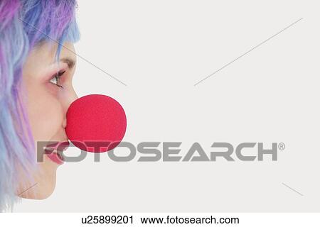 Profile of woman with red clown nose over gray background View Large Photo Image Stock Image - Profile of woman with red clown nose over gray background. Fotosearch