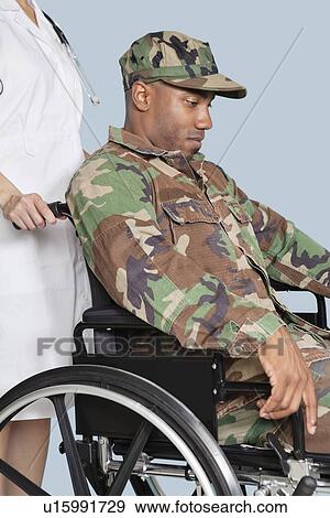 Sad US Marine Corps soldier wearing camouflage uniform in wheelchair assisted by female nurse View Large Photo Image Stock Photo - Sad US Marine Corps soldier wearing camouflage uniform in wheelchair assisted by female nurse. Fotosearch
