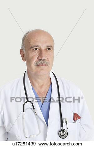 Stock Photo - Senior male doctor with stethoscope over gray background. Fotosearch