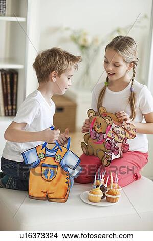 Siblings looking into each others bags View Large Photo Image Picture - Siblings looking into each others bags. Fotosearch