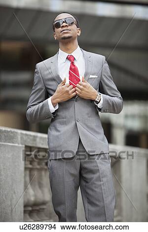 Smart African American young businessman wearing sunglasses View Large Photo Image Picture - Smart African American young businessman wearing sunglasses. Fotosearch