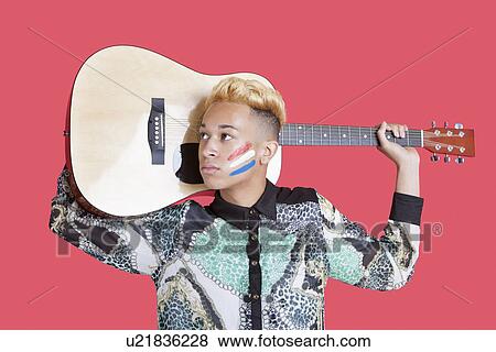 Teenage boy carrying guitar with Dutch flag on his face over pink background View Large Photo Image Stock Photo - Teenage boy carrying guitar with Dutch flag on his face over pink background. Fotosearch