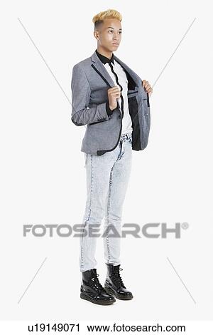 Teenage boy in smart casuals over gray background View Large Photo Image Stock Image - Teenage boy in smart casuals over gray background. Fotosearch