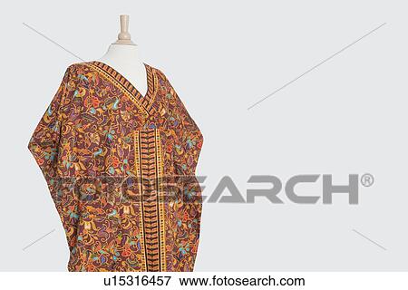 Traditional African dashiki on tailor's dummy over gray background View Large Photo Image Stock Photo - Traditional African dashiki on tailor's dummy over gray background. Fotosearch
