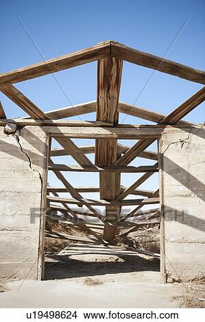 Picture - View of abandoned house against clear blue sky. Fotosearch