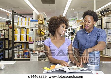 Young African American couple buying painting tools at super market View Large Photo Image Stock Photo - Young African American couple buying painting tools at super market. Fotosearch