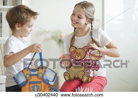 Young boy and girl holding their toy bags View Large Photo Image Stock Image - Young boy and girl holding their toy bags. Fotosearch