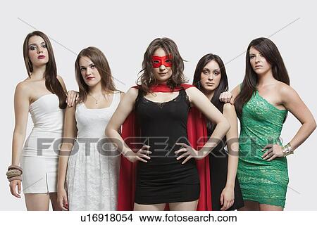 Young woman in superhero costume standing together with friends over gray background View Large Photo Image Picture - Young woman in superhero costume standing together with friends over gray background. Fotosearch