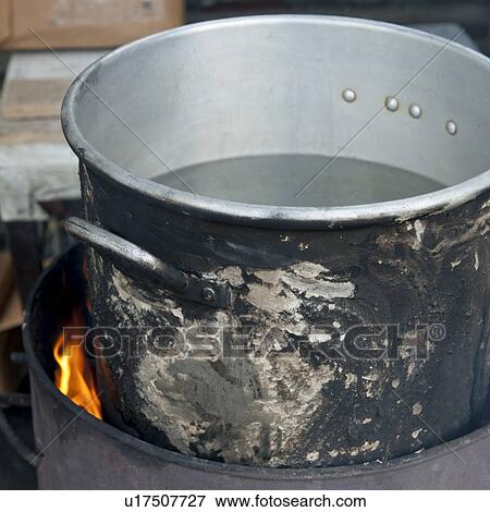 Stock Photo - Aluminum pot on fire, Colonia Landivar, Guatemala City, Guatemala. Fotosearch