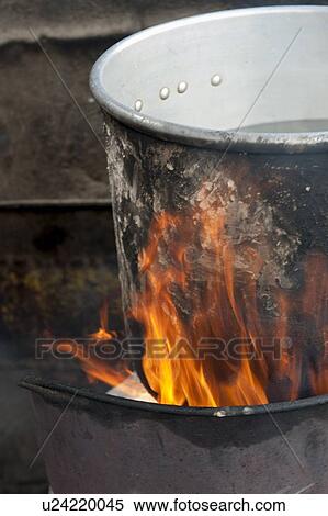 Stock Photography - Aluminum saucepan on fire, Colonia Landivar, Guatemala City, Guatemala. Fotosearch