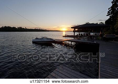 Boat docked at a pier, Lake of the Woods, Ontario, Canada View Large Photo Image Picture - Boat docked at a pier, Lake of the Woods, Ontario, Canada. Fotosearch