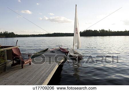 Stock Photograph - Boats at a pier, Lake of the Woods, Ontario, Canada. Fotosearch