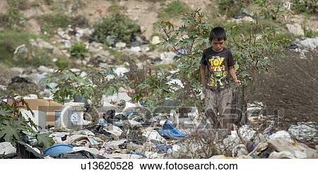 Boy collecting recyclable items from dump yard, Zona 3, Guatemala City, Guatemala View Large Photo Image Stock Photo - Boy collecting recyclable items from dump yard, Zona 3, Guatemala City, Guatemala. Fotosearch