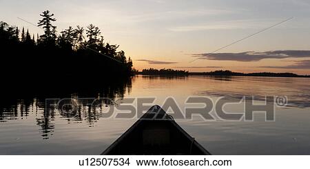 Canoe in a lake, Lake of the Woods, Ontario, Canada View Large Photo Image Picture - Canoe in a lake, Lake of the Woods, Ontario, Canada. Fotosearch