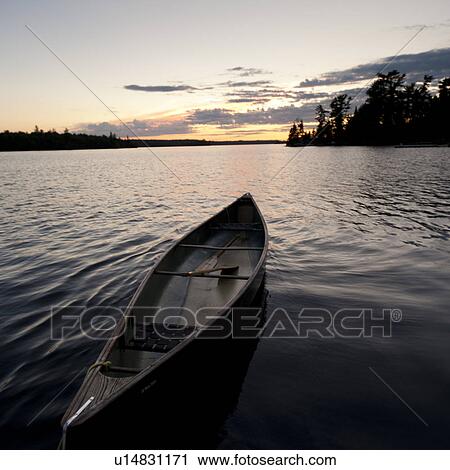 Stock Image - Canoe in a lake, Lake of the Woods, Ontario, Canada. Fotosearch