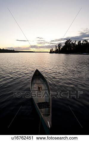 Stock Image - Canoe in a lake, Lake of the Woods, Ontario, Canada. Fotosearch