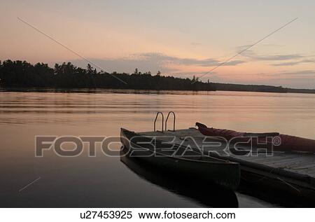 Stock Photography - Canoe near a pier in a lake, Lake of the Woods, Ontario, Canada. Fotosearch