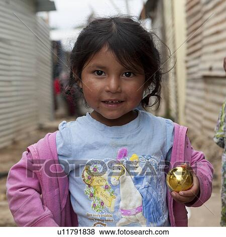 Close-up of a girl holding a metal ball, Colonia Landivar, Guatemala City, Guatemala View Large Photo Image Stock Photo - Close-up of a girl holding a metal ball, Colonia Landivar, Guatemala City, Guatemala. Fotosearch