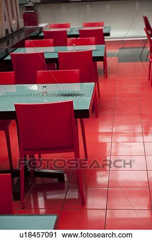 Stock Image - Empty tables and chairs in a restaurant, Zona 10, Guatemala City, Guatemala. Fotosearch