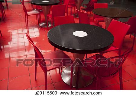 Stock Photo - Empty tables and chairs in a restaurant, Zona 10, Guatemala City, Guatemala. Fotosearch