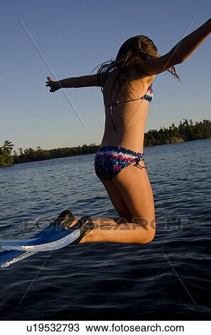 Girl jumping into a lake, Lake of the Woods, Ontario, Canada View Large Photo Image Stock Image - Girl jumping into a lake, Lake of the Woods, Ontario, Canada. Fotosearch