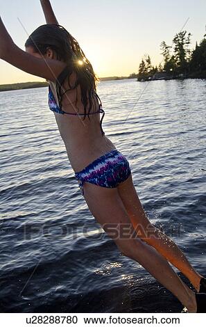 Girl jumping into a lake, Lake of the Woods, Ontario, Canada View Large Photo Image Stock Image - Girl jumping into a lake, Lake of the Woods, Ontario, Canada. Fotosearch