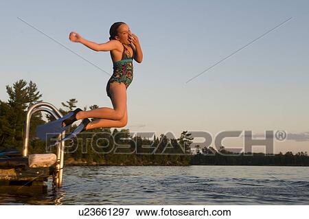 Girl jumping into a lake, Lake of the Woods, Ontario, Canada View Large Photo Image Stock Photo - Girl jumping into a lake, Lake of the Woods, Ontario, Canada. Fotosearch