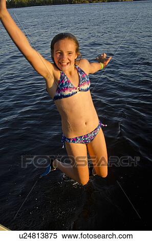 Girl jumping into a lake, Lake of the Woods, Ontario, Canada View Large Photo Image Stock Photography - Girl jumping into a lake, Lake of the Woods, Ontario, Canada. Fotosearch